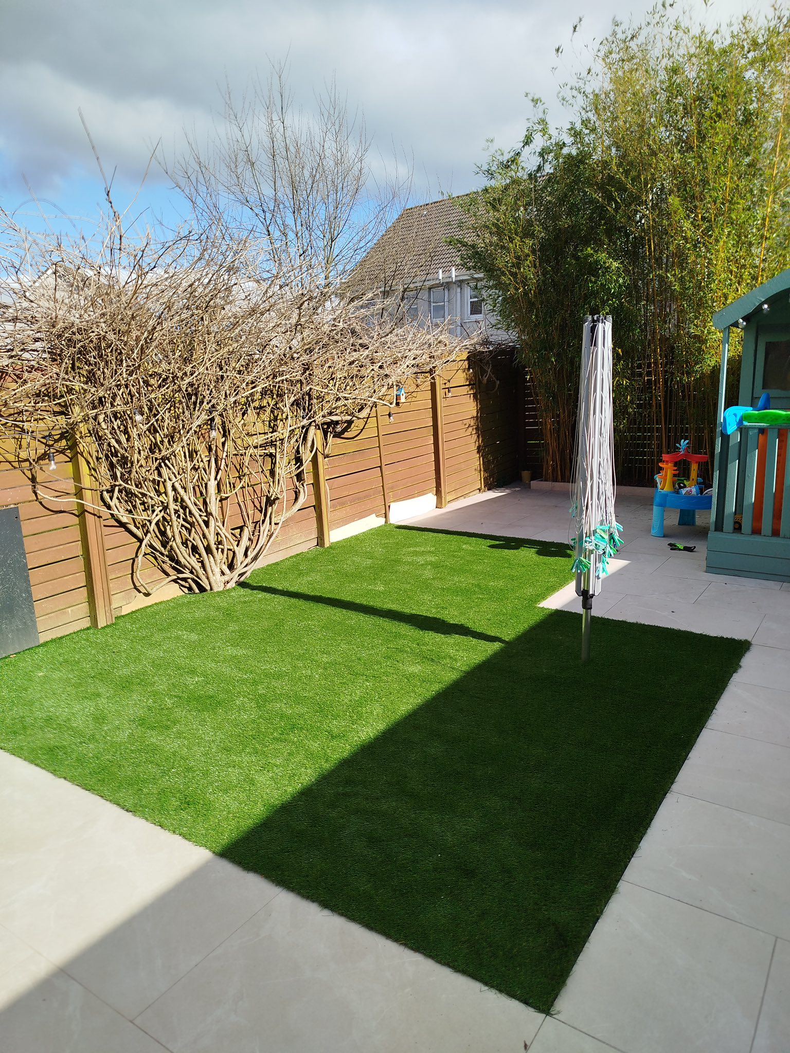 Garden with artificial grass, paving and timber fencing